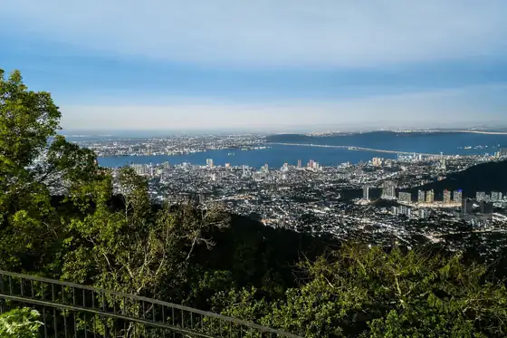 Widok z Penang Hill na Air Itam, z zatoką, miastem i zielenią na pierwszym planie.