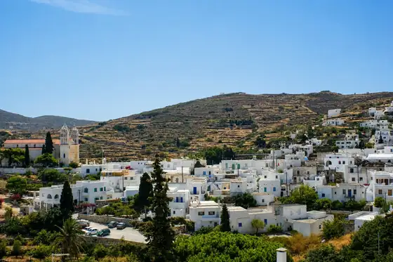 Lefkes na Paros z białymi domami, kościołem i wzgórzem w tle