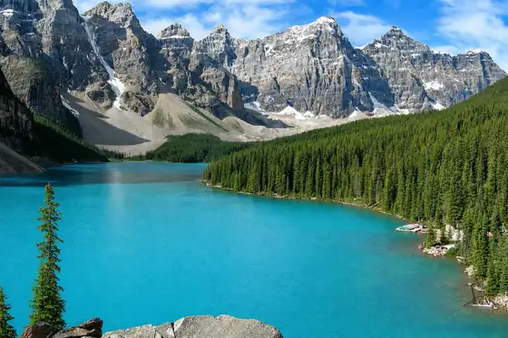 Jezioro Moraine w Parku Narodowym Banff w Kanadzie z turkusową wodą i górami w tle.